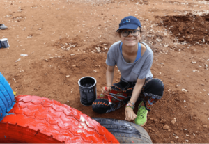 Volunteer painting childrens playground equipment