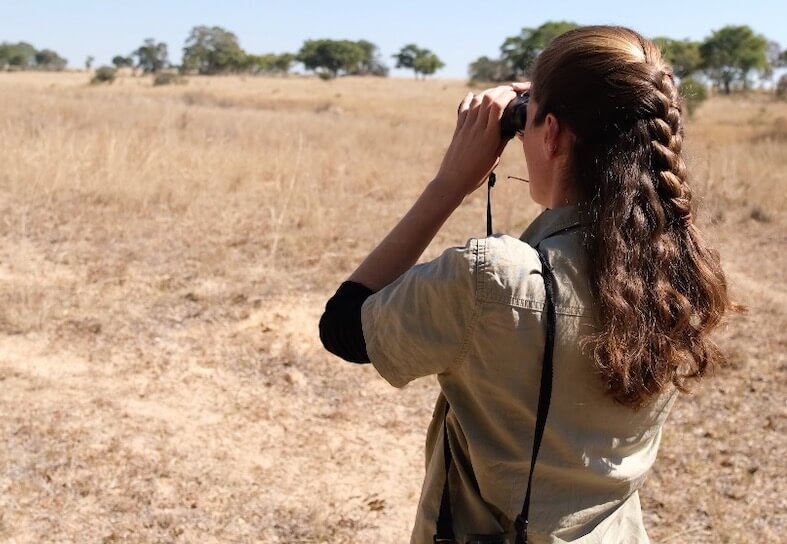 Girl looking at wildlife through binoculars