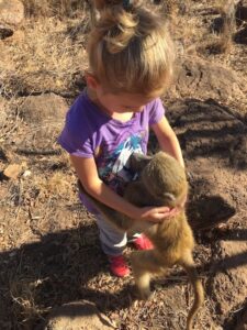 girl volunteering with baboon