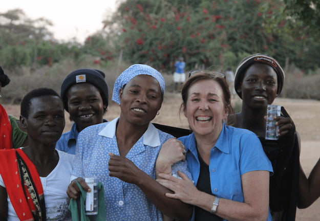 Mature volunteer with group of African women