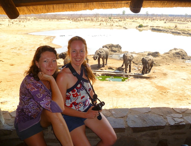 HWA-two volunteers watching elephants at a waterhole