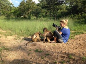 Girl with camera and baboon