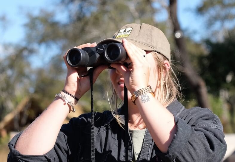 Volunteering looking through binoculars