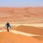 Girl hiking Sossusvlei dunes