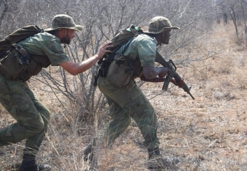 two anti-poaching rangers on foot patrol