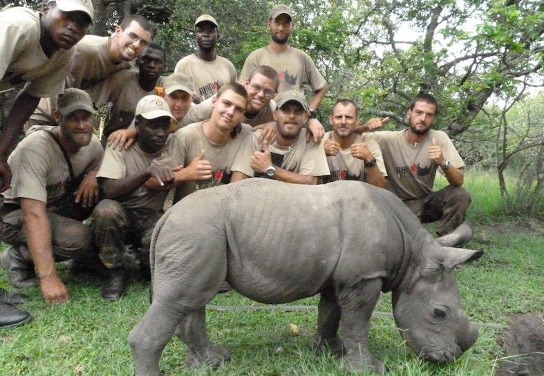 anti-poaching students with rescued baby rhino