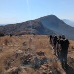 Anti-poaching volunteers hiking up to a peak