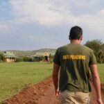 Anti-poaching volunteer walking towards camp