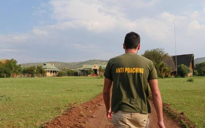 Anti-poaching volunteer walking towards camp