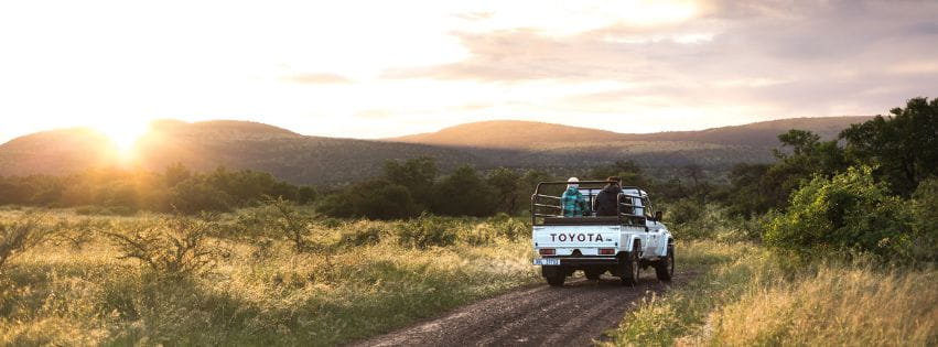 Safari vehicle at sunrise