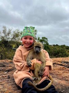 Family volunteer with baboon