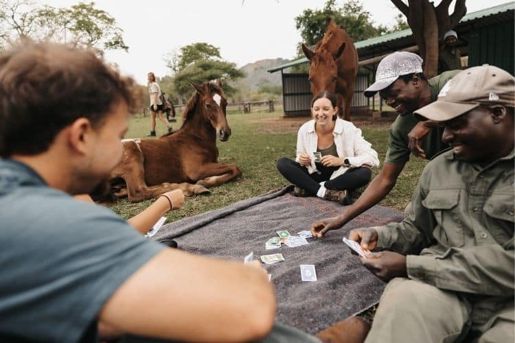 Working holiday volunteers playing cards