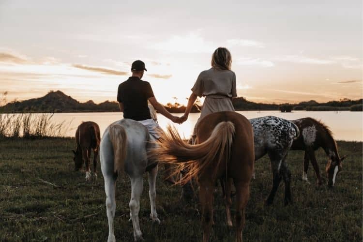 two horse volunteers at sunset