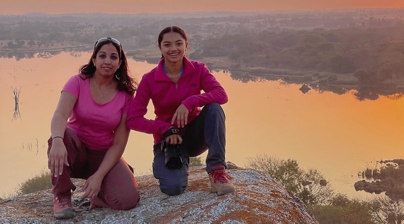 Volunteer mother and daughter with lake in background